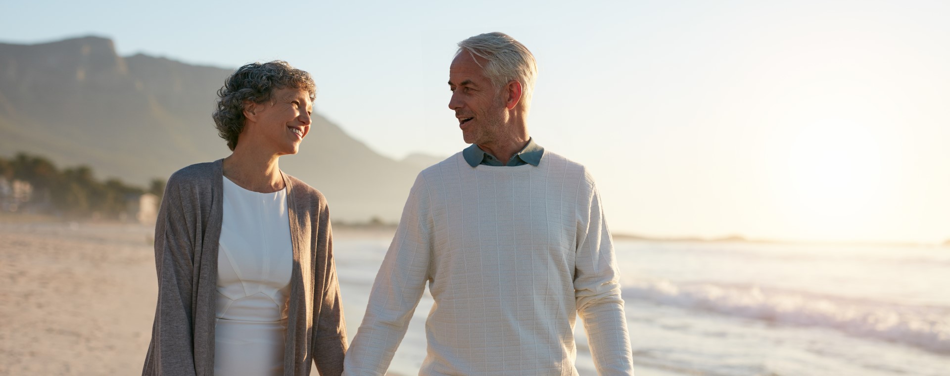 retired couple walking on the beach